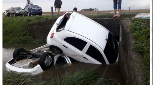Dos automóviles patinaron por la ruta mojada y cayeron a un arroyo